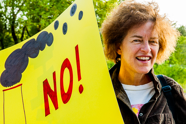 woman holding yellow sign "NO!