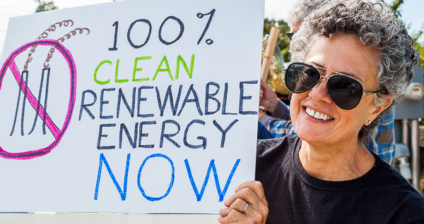 Demonstrator displays sign for passing traffic